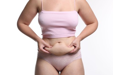 Photo of Liposuction. Woman in underwear touching her belly on white background, closeup
