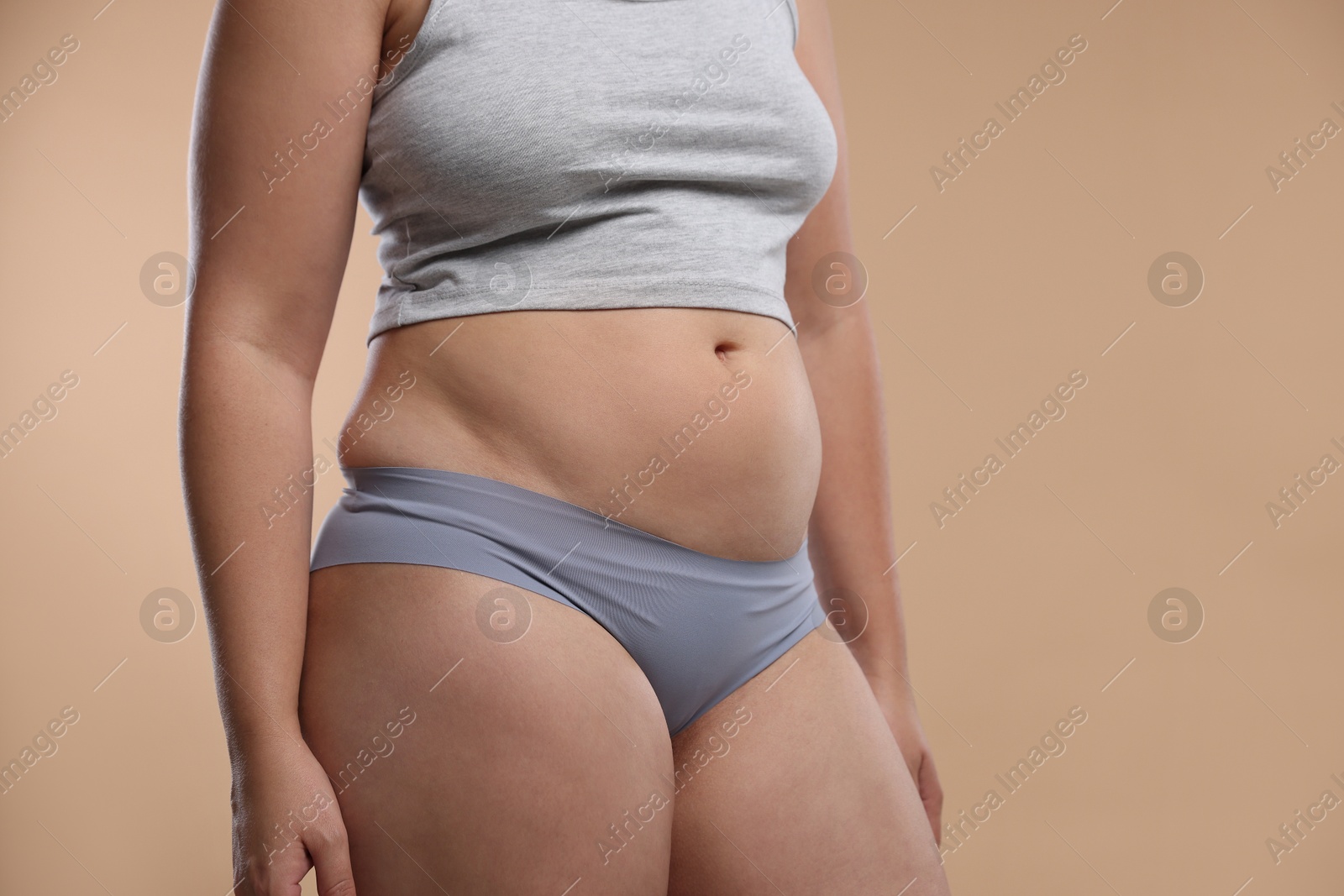 Liposuction. Woman in underwear on beige background, closeup Photo of Liposuction. Woman in underwear on beige background, closeup