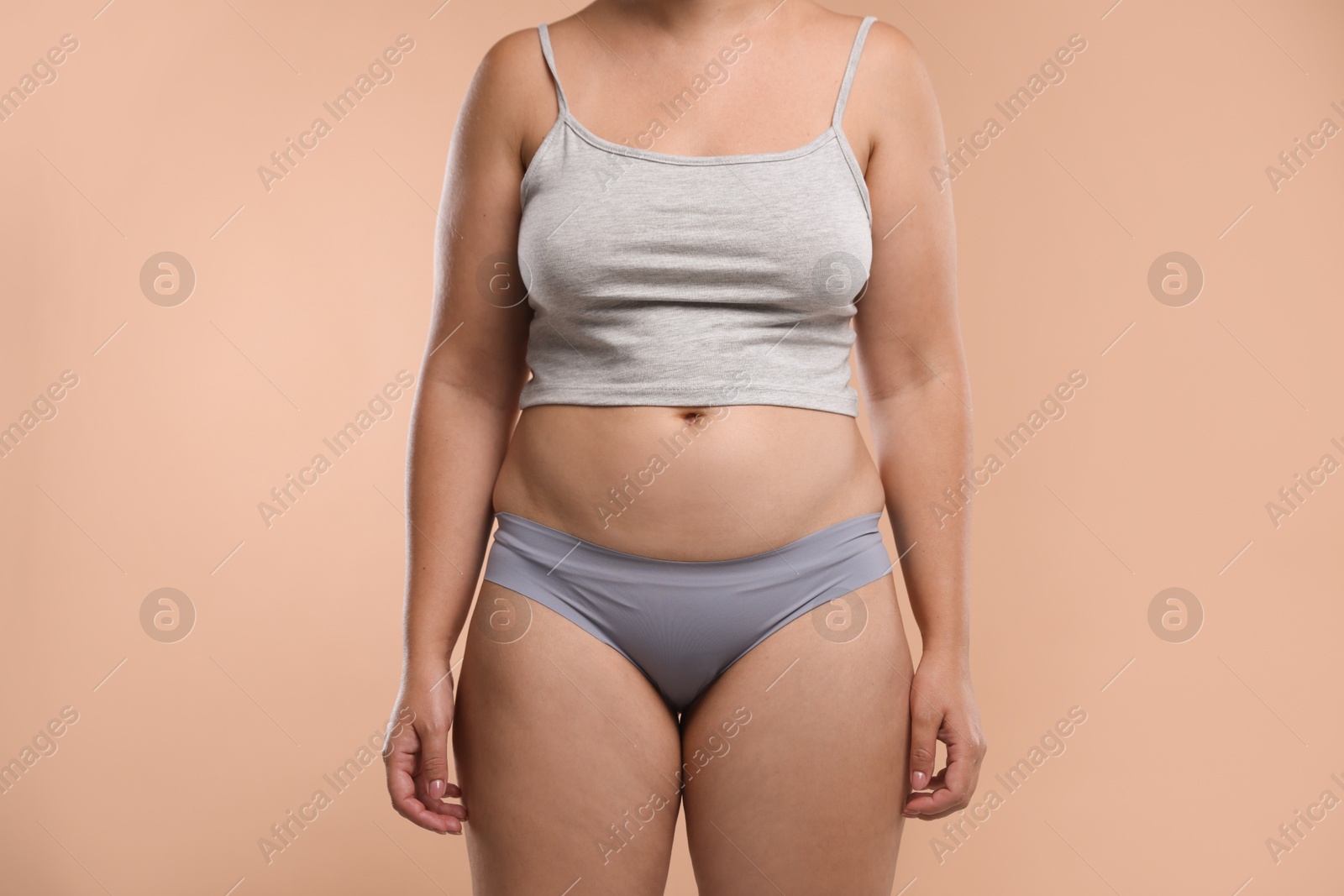 Photo of Liposuction. Woman in underwear on beige background, closeup