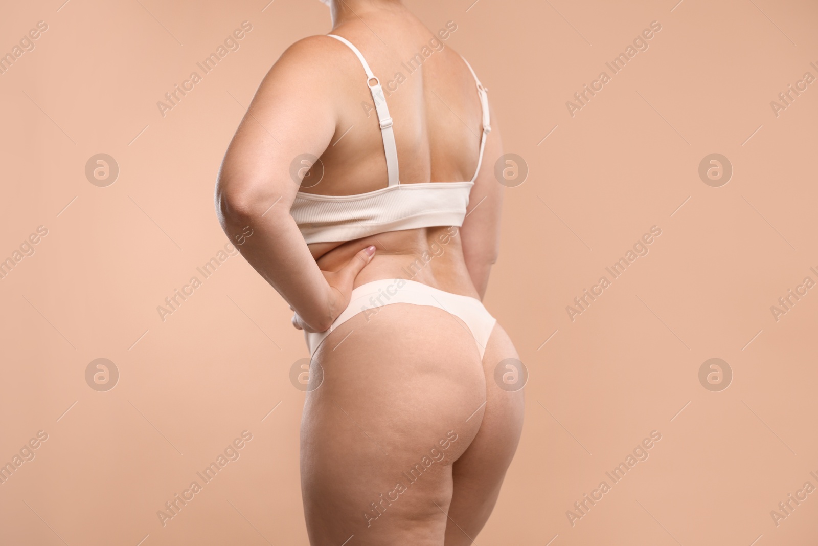 Photo of Liposuction. Woman in underwear on beige background, closeup