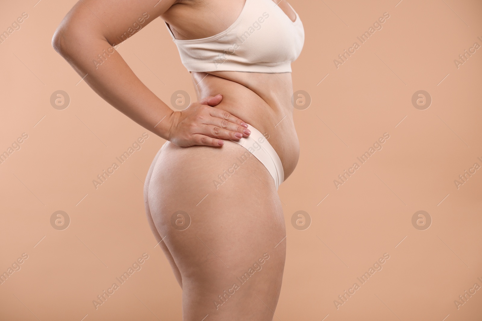 Photo of Liposuction. Woman in underwear on beige background, closeup
