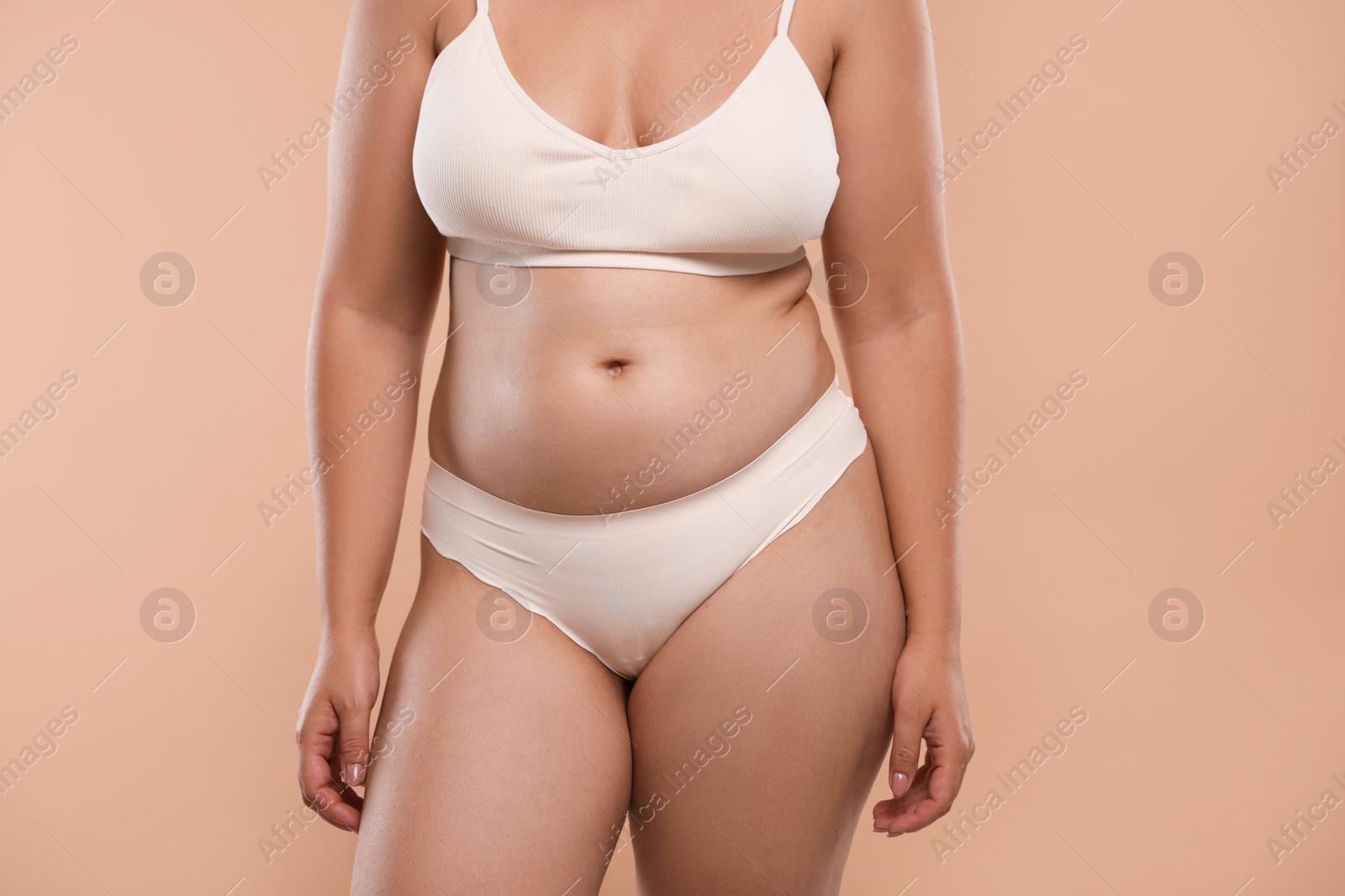 Photo of Liposuction. Woman in underwear on beige background, closeup