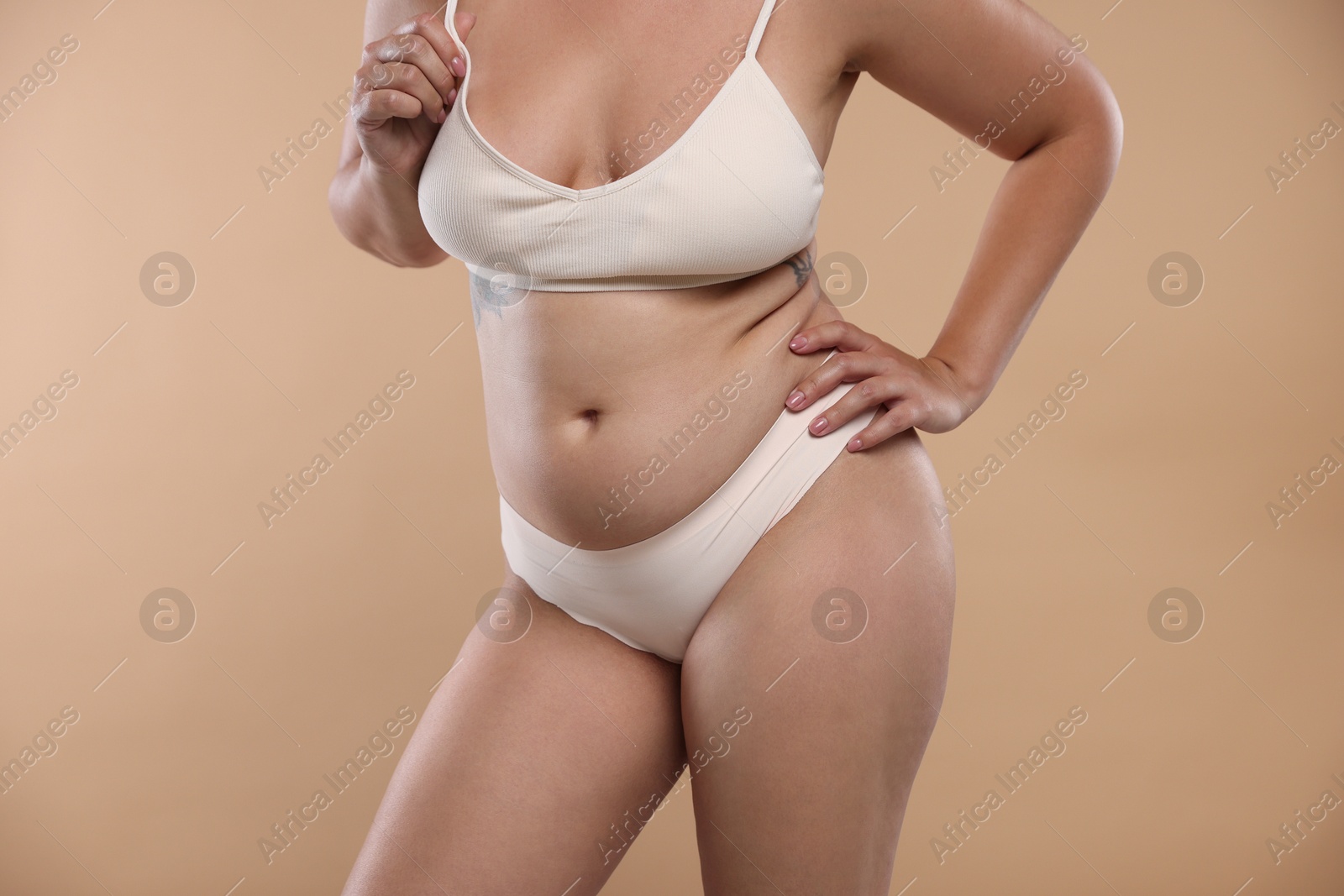 Liposuction. Woman in underwear on beige background, closeup Photo of Liposuction. Woman in underwear on beige background, closeup
