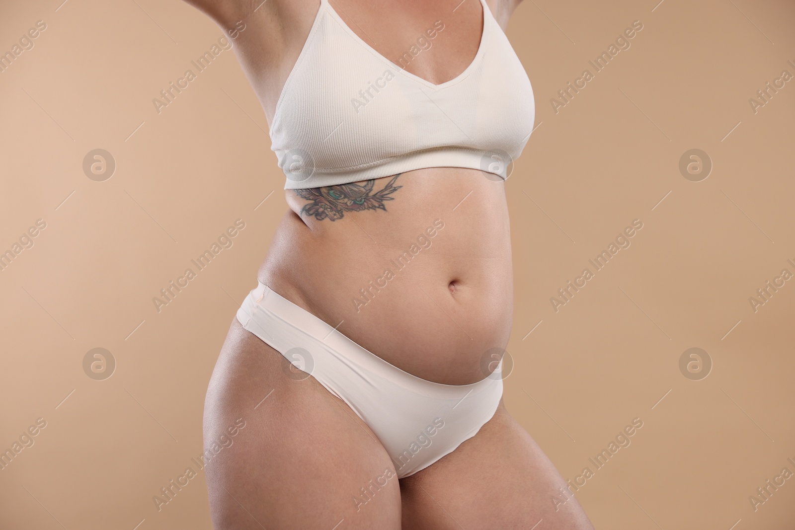 Photo of Liposuction. Woman in underwear on beige background, closeup