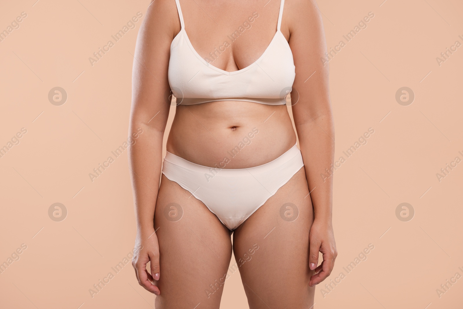 Photo of Liposuction. Woman in underwear on beige background, closeup