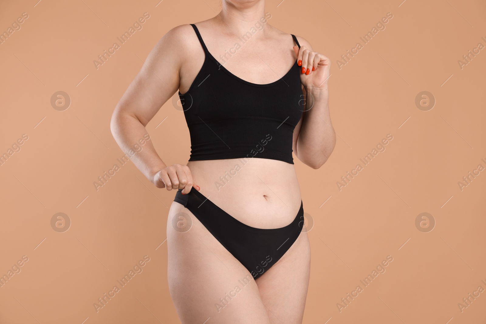 Liposuction. Woman in underwear on beige background, closeup Photo of Liposuction. Woman in underwear on beige background, closeup