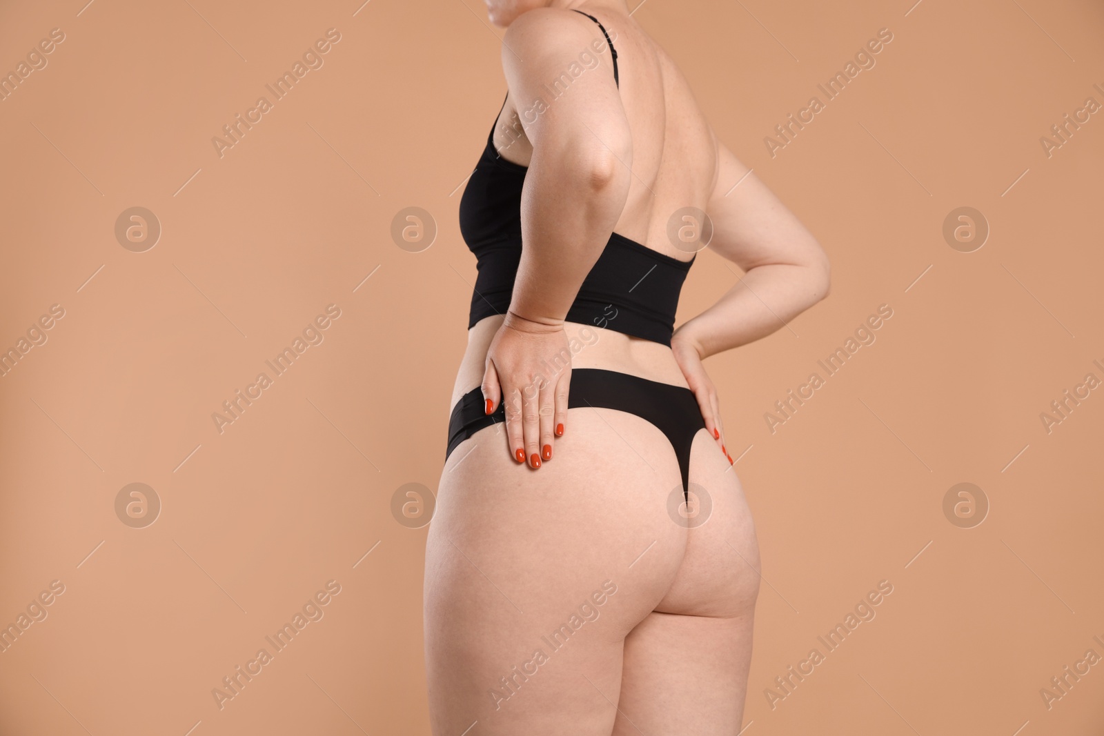 Photo of Liposuction. Woman in underwear on beige background, closeup