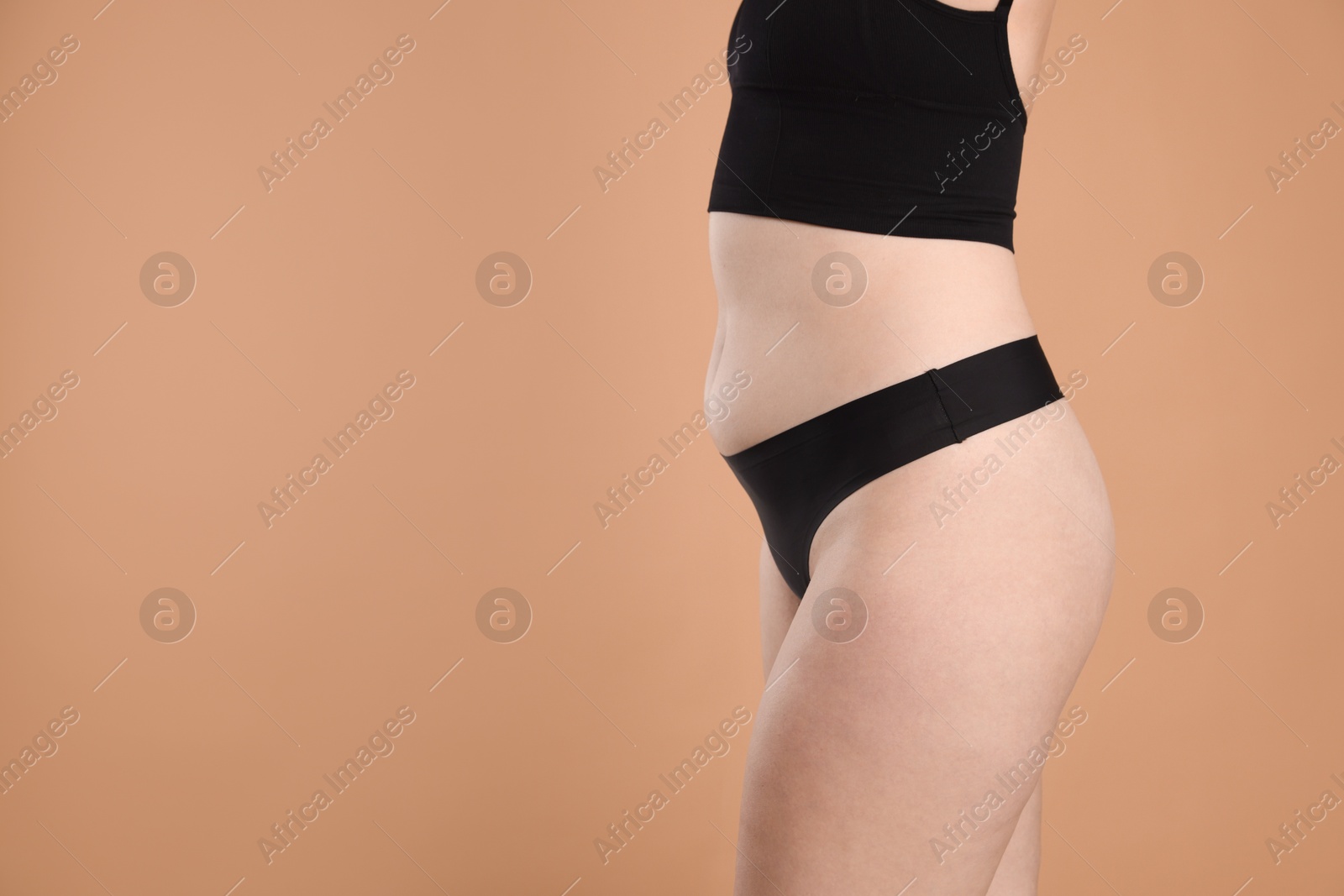 Liposuction. Woman in underwear on beige background, closeup. Space for text Photo of Liposuction. Woman in underwear on beige background, closeup. Space for text