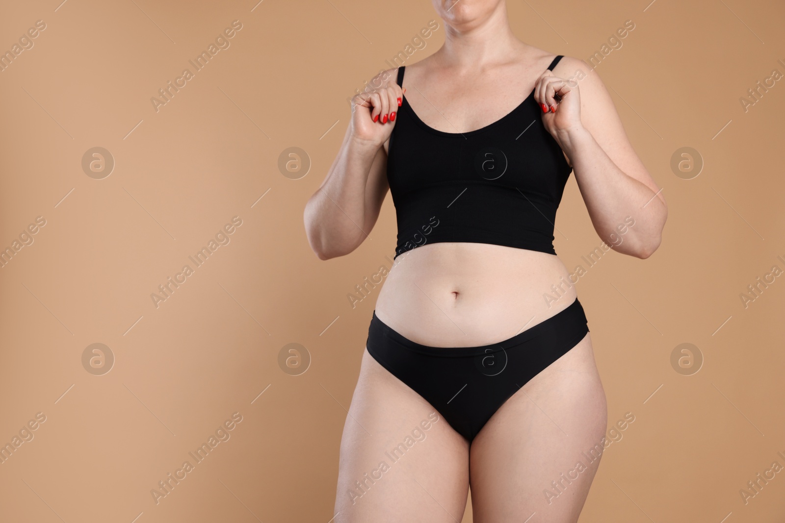Liposuction. Woman in underwear on beige background, closeup. Space for text Photo of Liposuction. Woman in underwear on beige background, closeup. Space for text