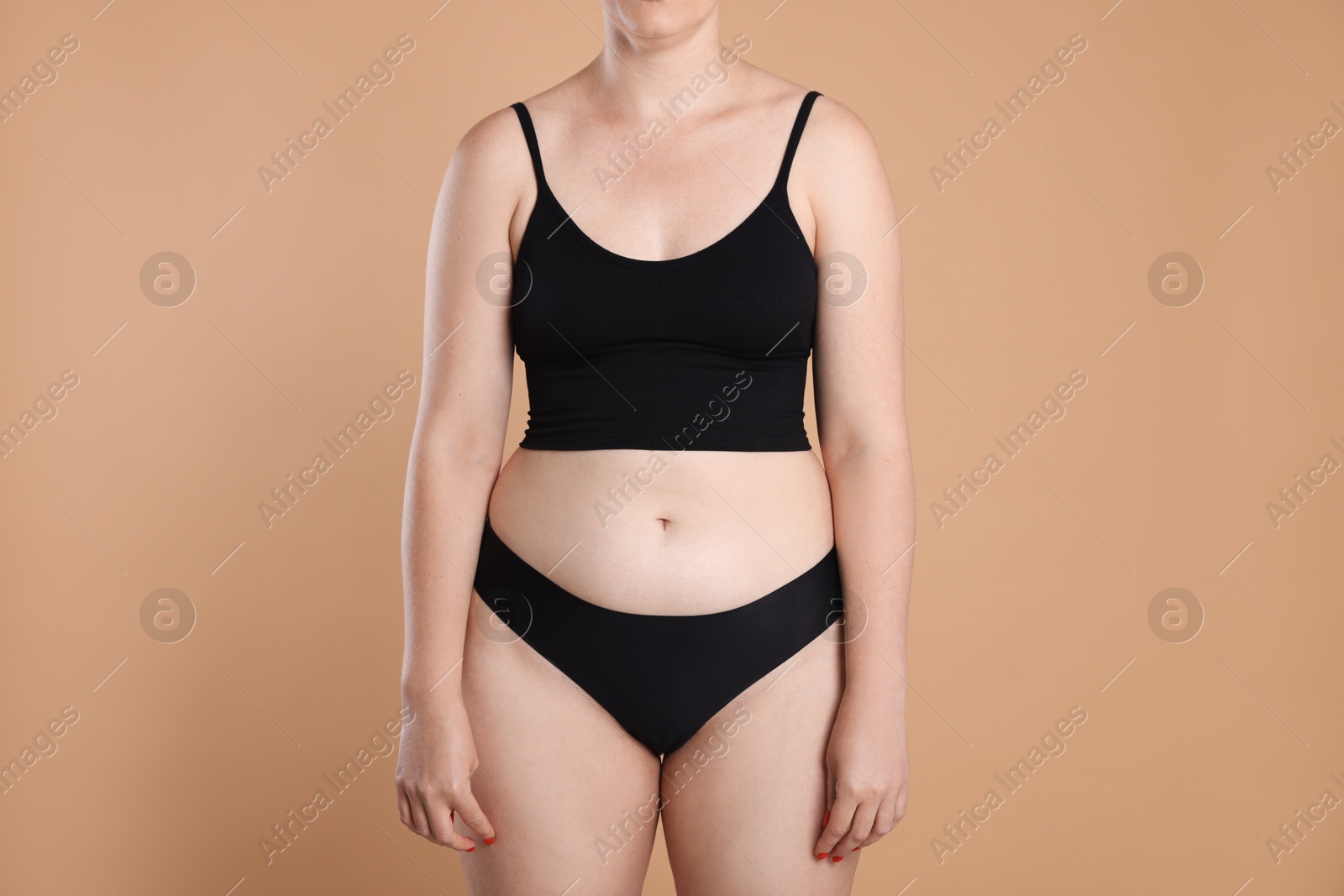 Liposuction. Woman in underwear on beige background, closeup Photo of Liposuction. Woman in underwear on beige background, closeup