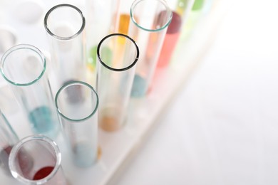 Photo of Solution chemistry. Test tubes with different samples on table, above view. Space for text
