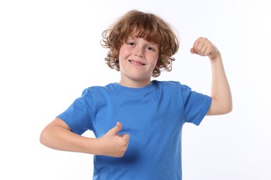 Photo of Strength. Happy little boy showing his biceps and thumbs up on white background