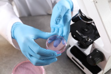 Photo of Scientist working with sample at grey table, above view