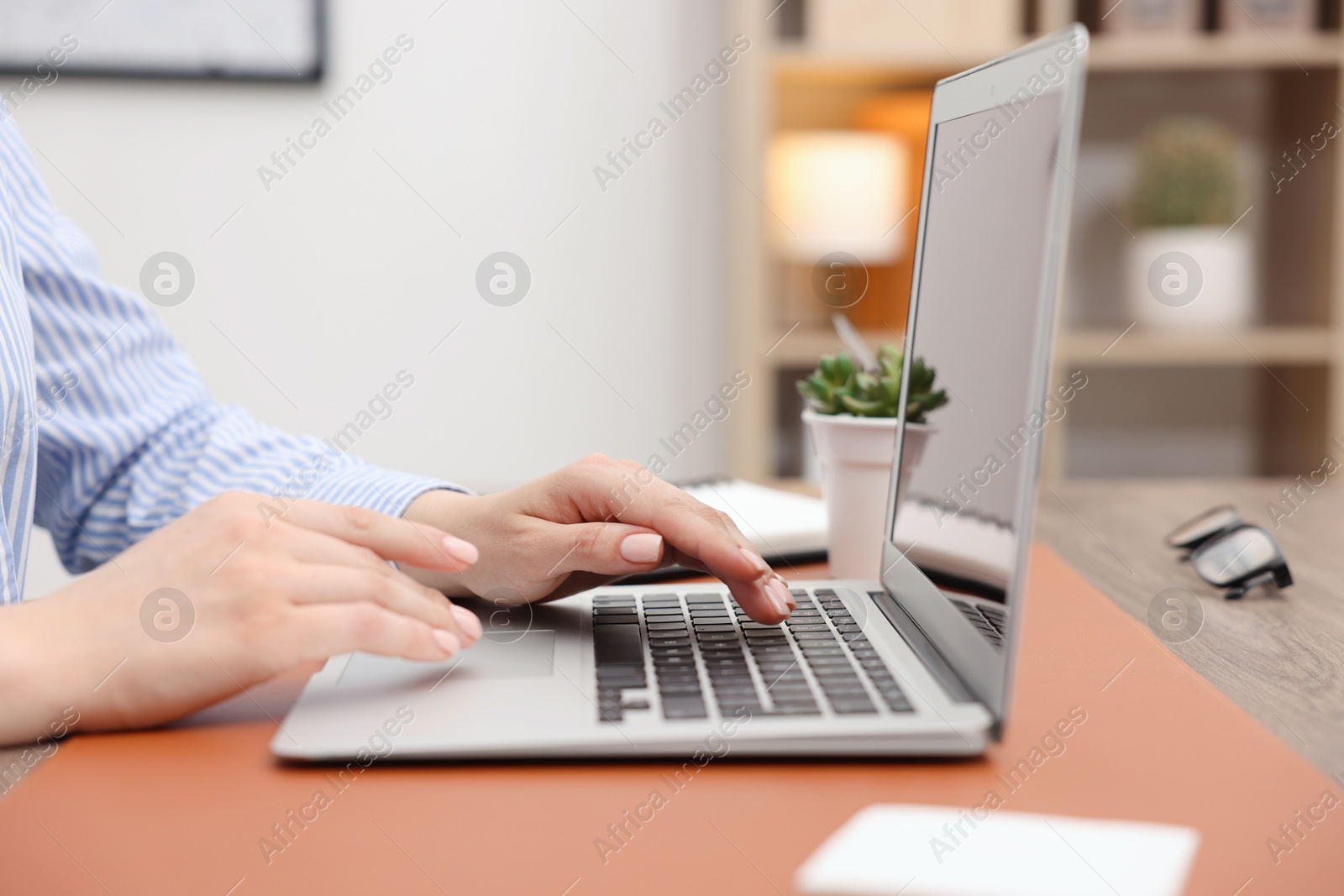 Copywriter using laptop at table indoors, closeup Photo of Copywriter using laptop at table indoors, closeup