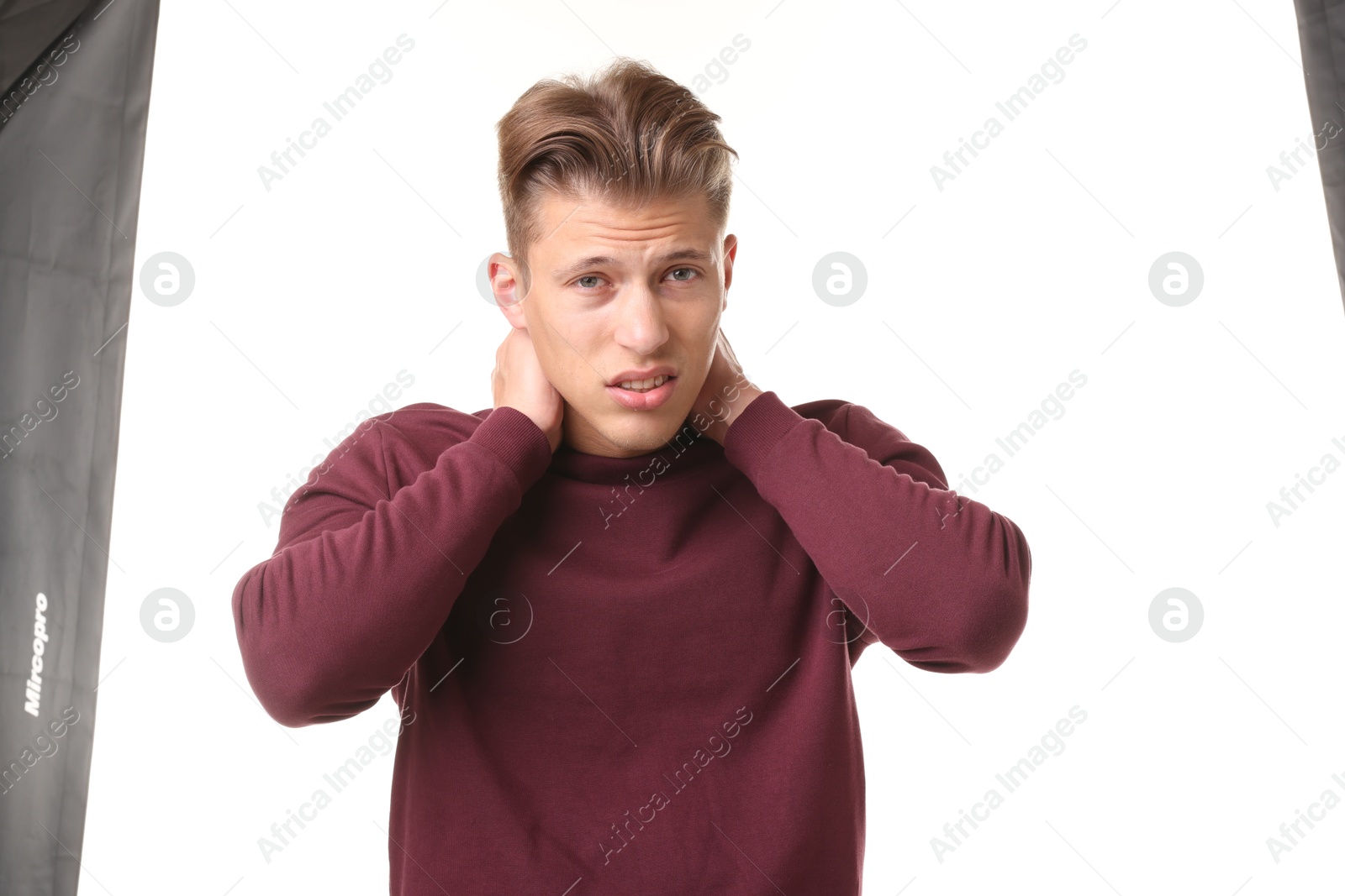 Photo of Young man suffering from neck pain on white background