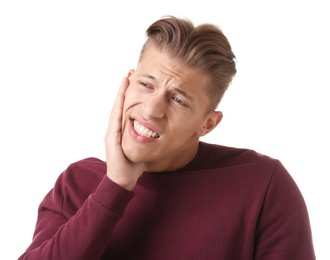 Photo of Young man suffering from toothache on white background
