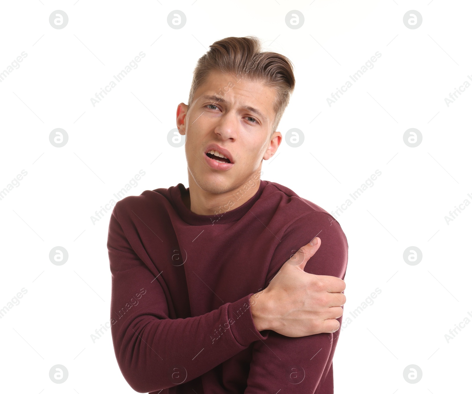 Young man suffering from shoulder pain on white background Photo of Young man suffering from shoulder pain on white background