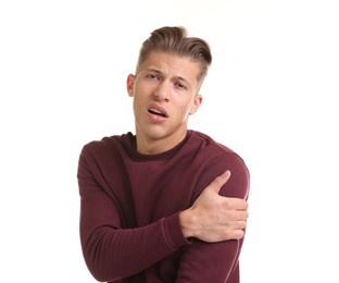 Photo of Young man suffering from shoulder pain on white background
