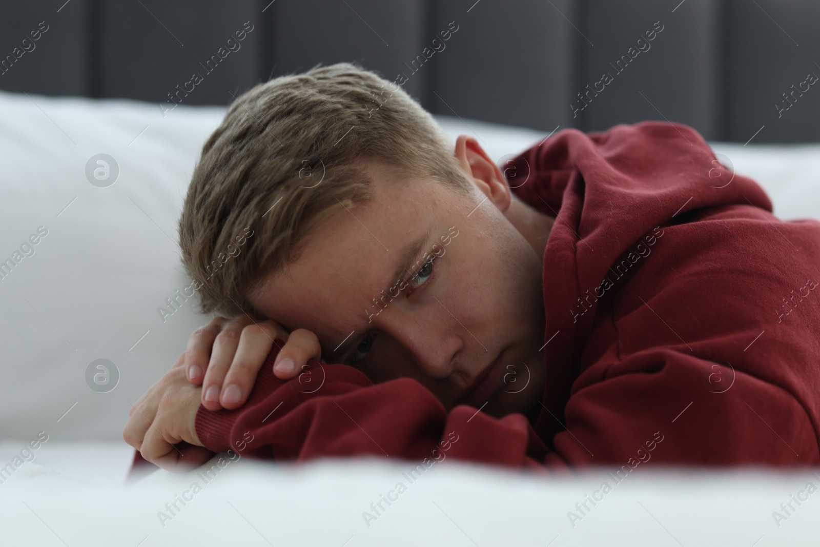Sad thoughtful man lying on bed. Depression Photo of Sad thoughtful man lying on bed. Depression