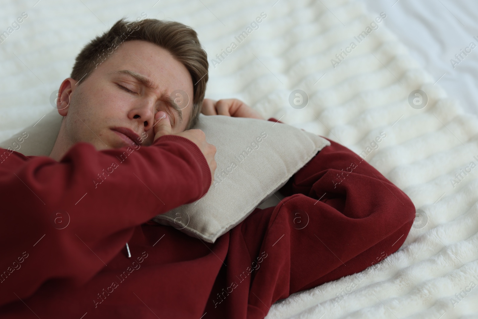 Sad man with pillow lying on bed. Depression Photo of Sad man with pillow lying on bed. Depression