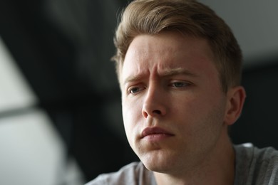 Photo of Sad man on blurred background, space for text. Depression
