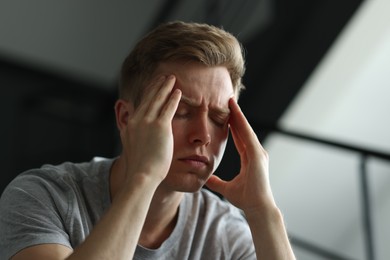 Photo of Sad man suffering on blurred background. Depression