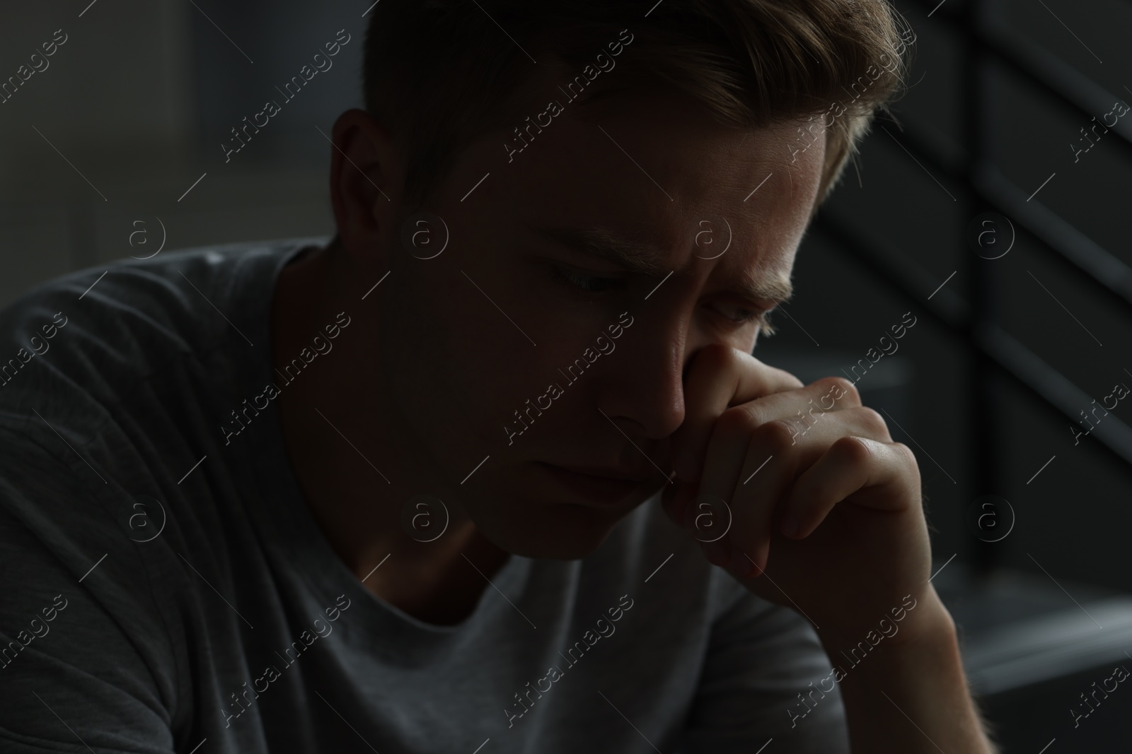 Sad man crying alone in darkness. Depression Photo of Sad man crying alone in darkness. Depression