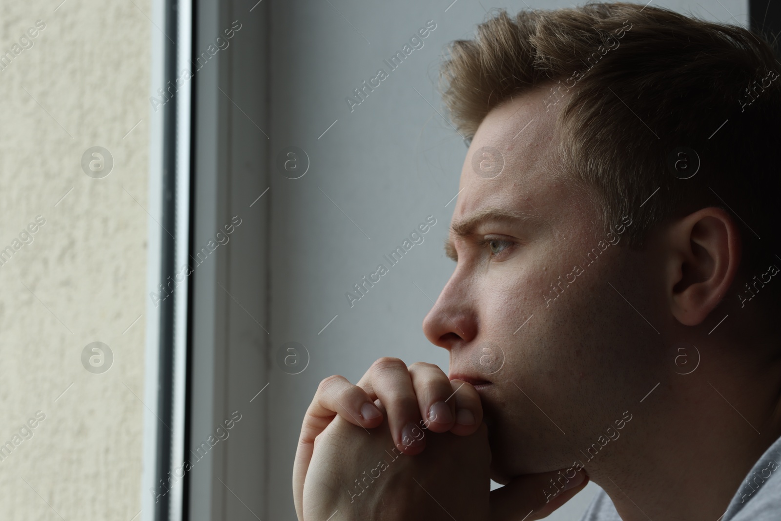 Sad thoughtful man looking at window indoors, space for text. Depression Photo of Sad thoughtful man looking at window indoors, space for text. Depression