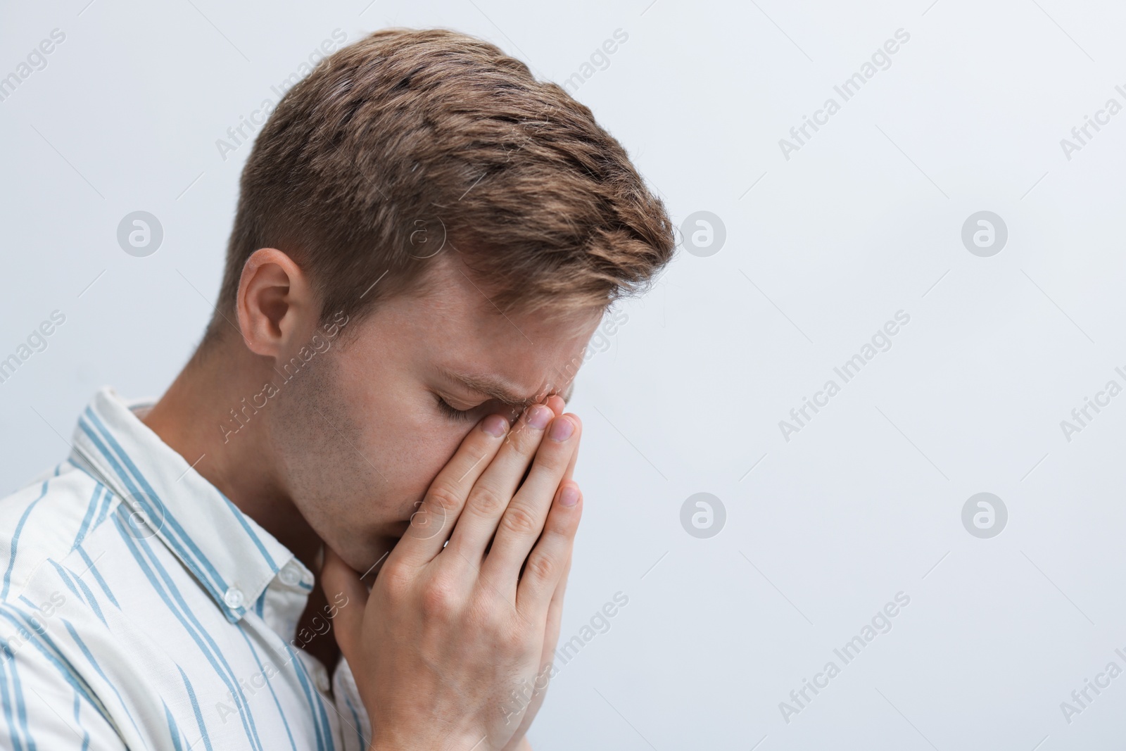 Sad tired man on light background. Space for text Photo of Sad tired man on light background. Space for text