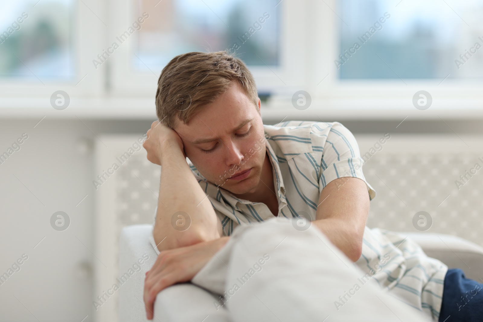 Sad thoughtful man on sofa at home Photo of Sad thoughtful man on sofa at home