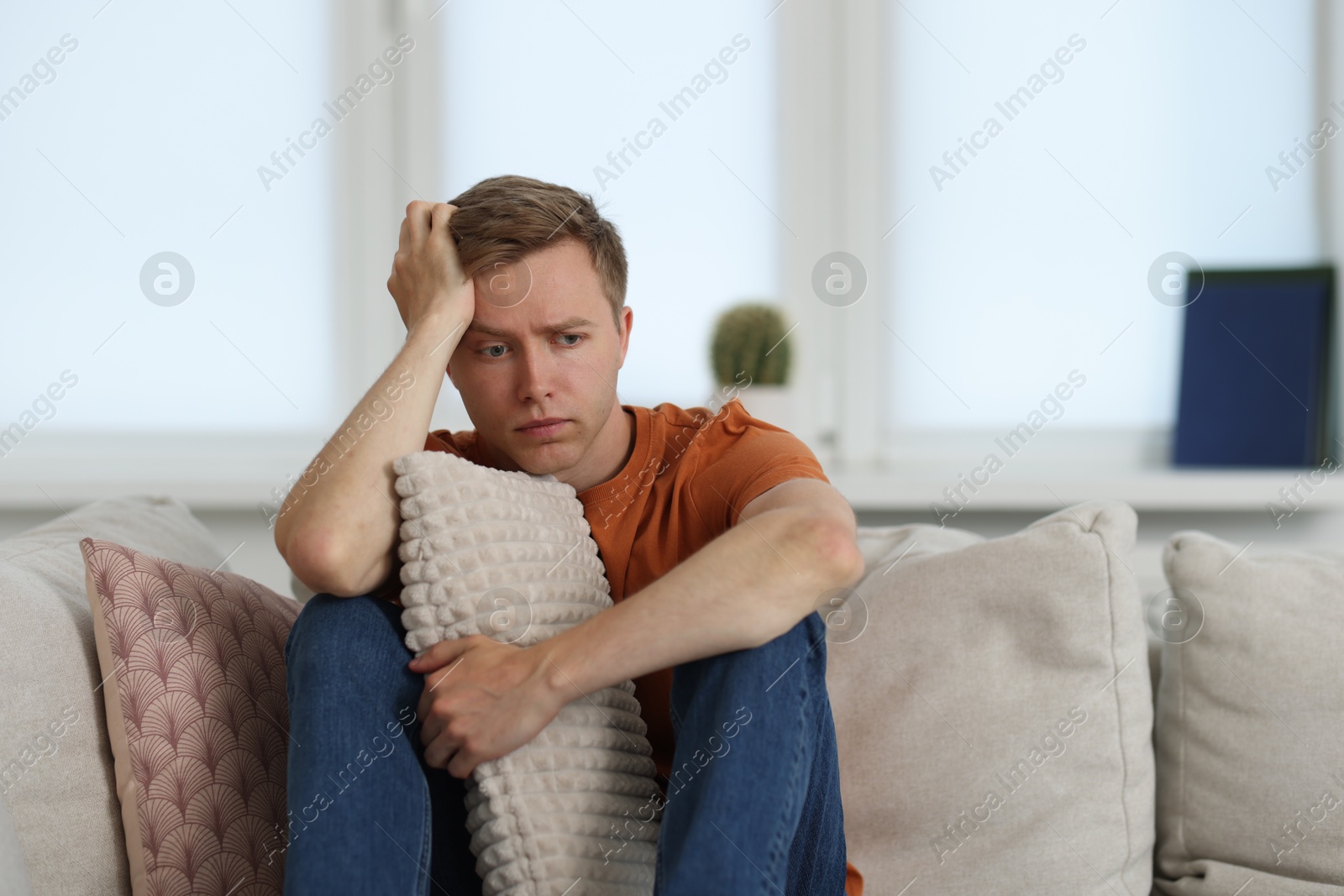 Sad thoughtful man on sofa at home Photo of Sad thoughtful man on sofa at home