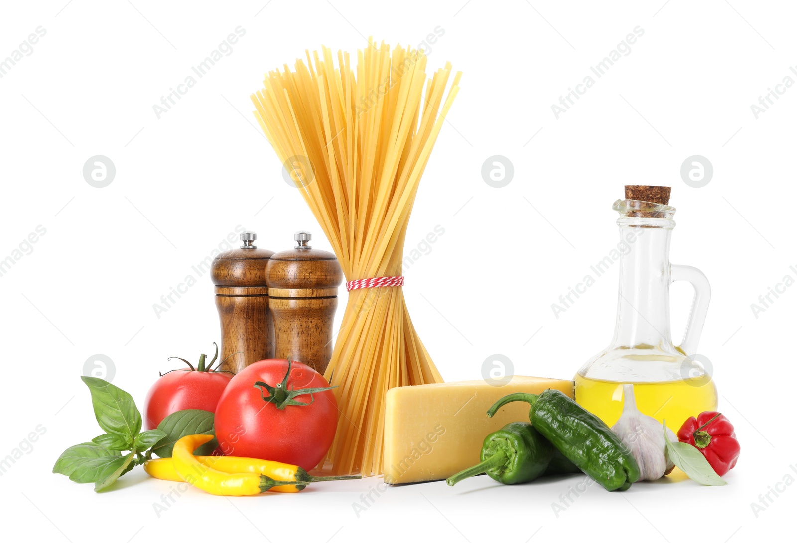 Photo of Raw spaghetti pasta and different ingredients isolated on white