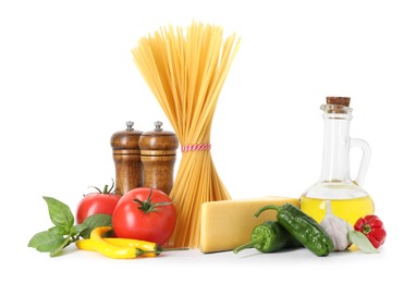 Photo of Raw spaghetti pasta and different ingredients isolated on white