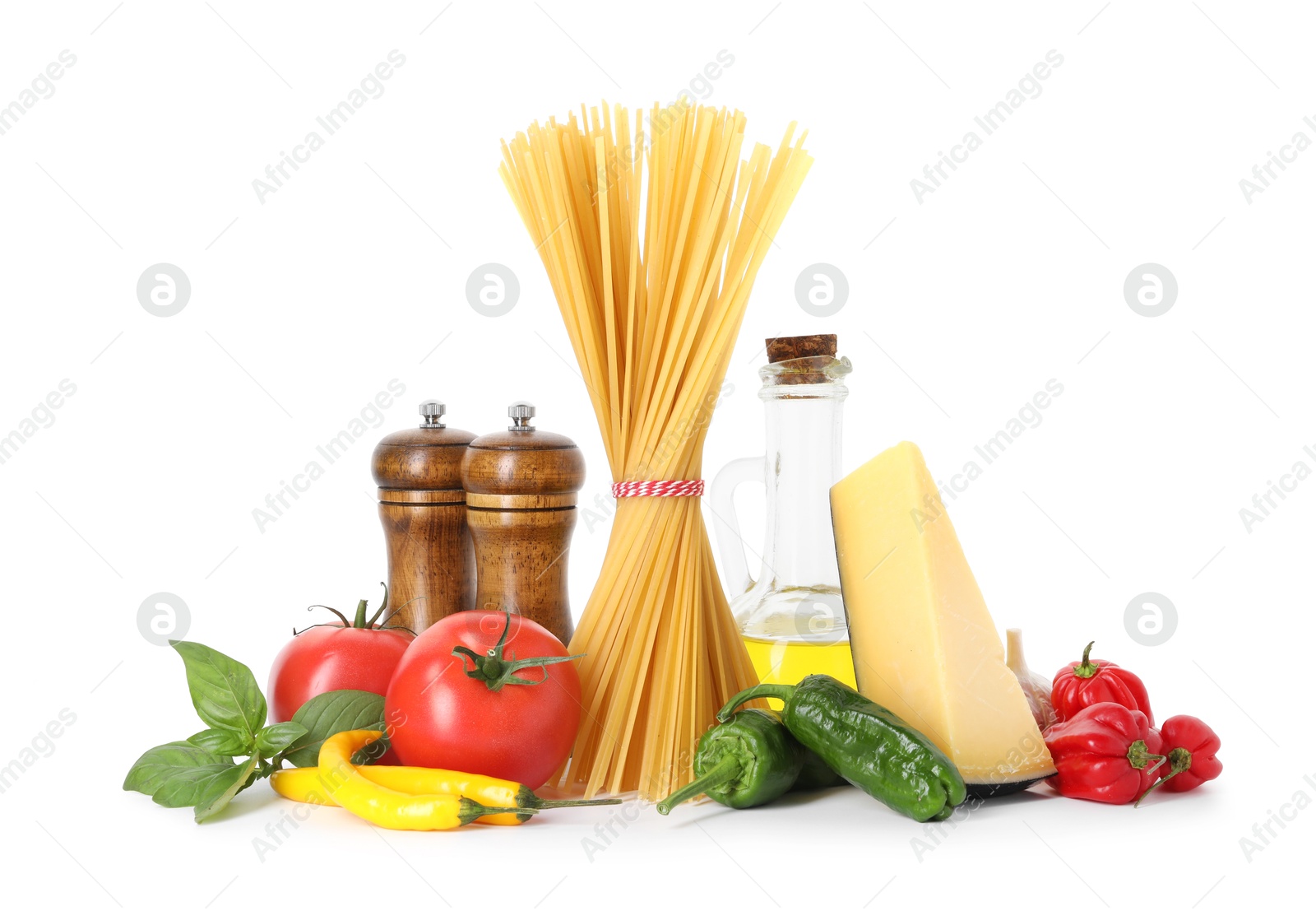 Photo of Raw spaghetti pasta and different ingredients isolated on white