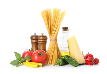 Photo of Raw spaghetti pasta and different ingredients isolated on white