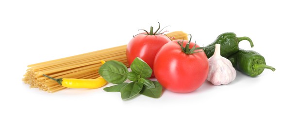 Photo of Raw spaghetti pasta and different ingredients isolated on white