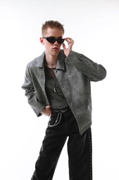 Photo of Handsome young man wearing stylish jacket and sunglasses on white background