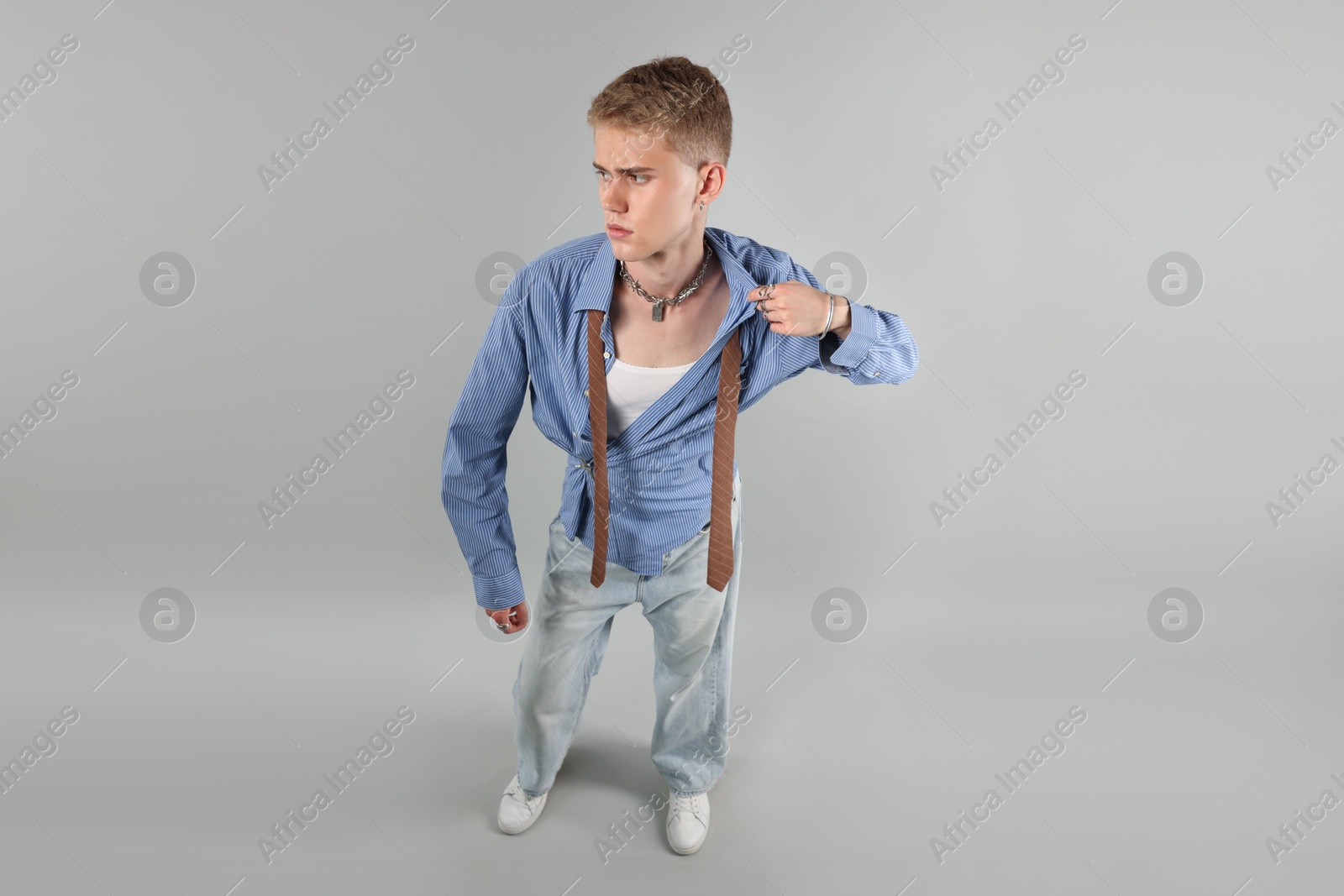 Photo of Handsome young man wearing stylish clothes on light grey background, above view