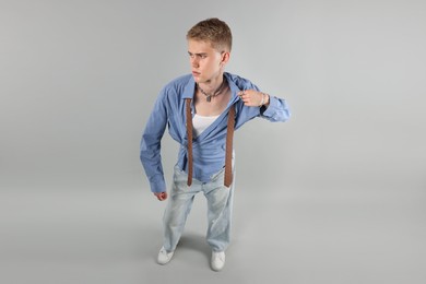 Photo of Handsome young man wearing stylish clothes on light grey background, above view