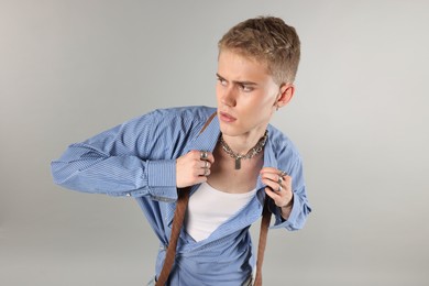 Photo of Handsome young man wearing stylish clothes on light grey background, above view