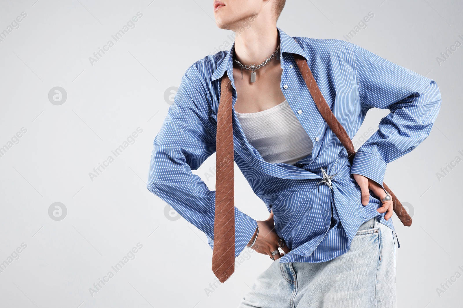 Photo of Young man wearing stylish clothes on light grey background, closeup. Space for text