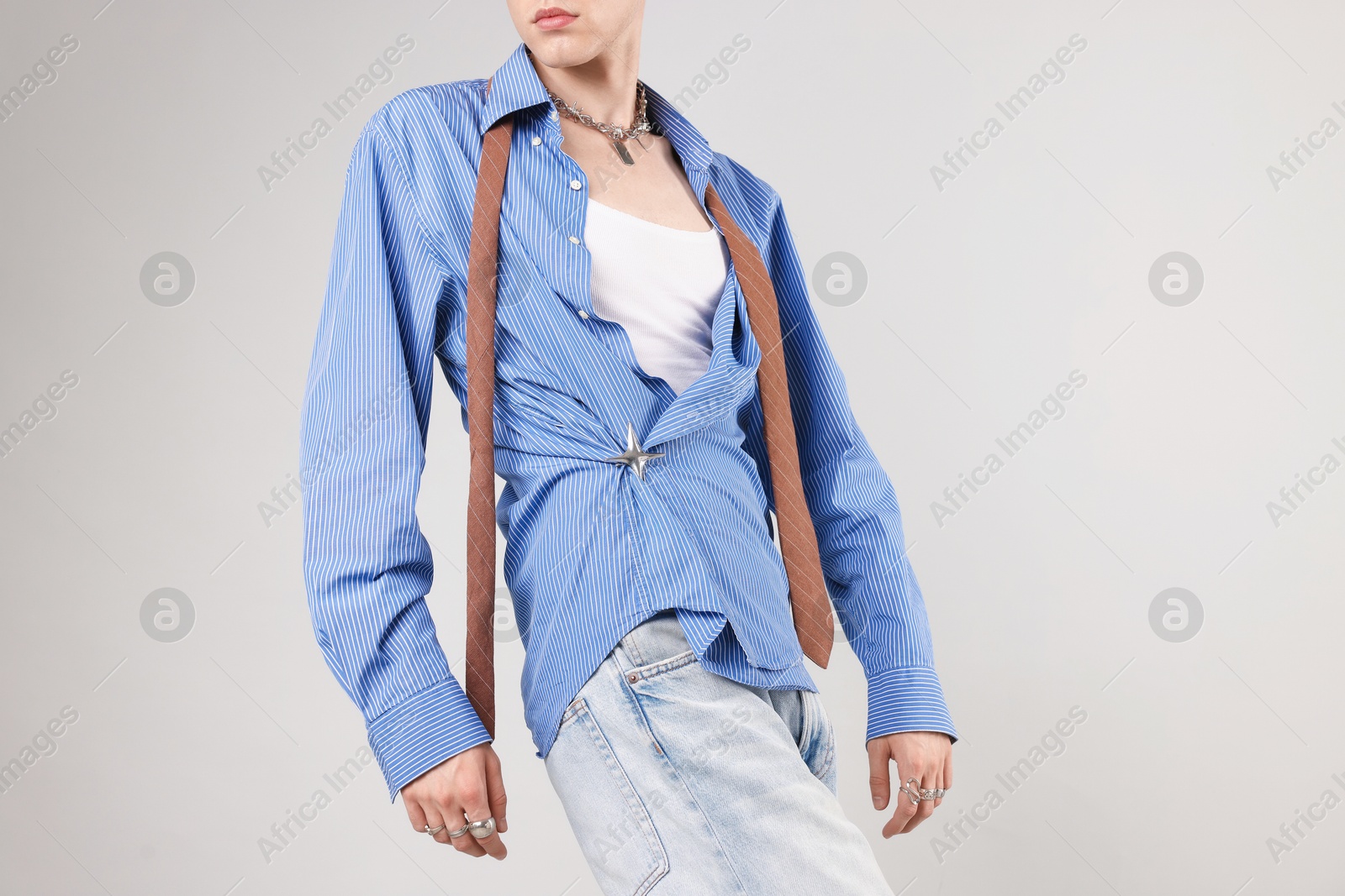 Photo of Young man wearing stylish clothes on light grey background, closeup