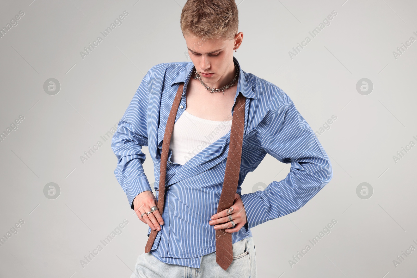 Photo of Handsome young man wearing stylish clothes on light grey background