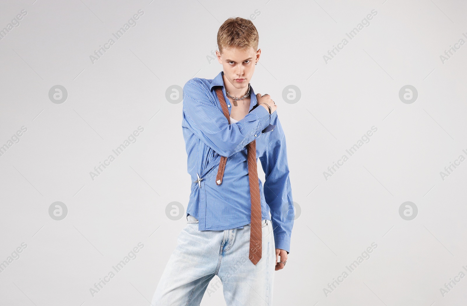 Photo of Handsome young man wearing stylish clothes on light grey background