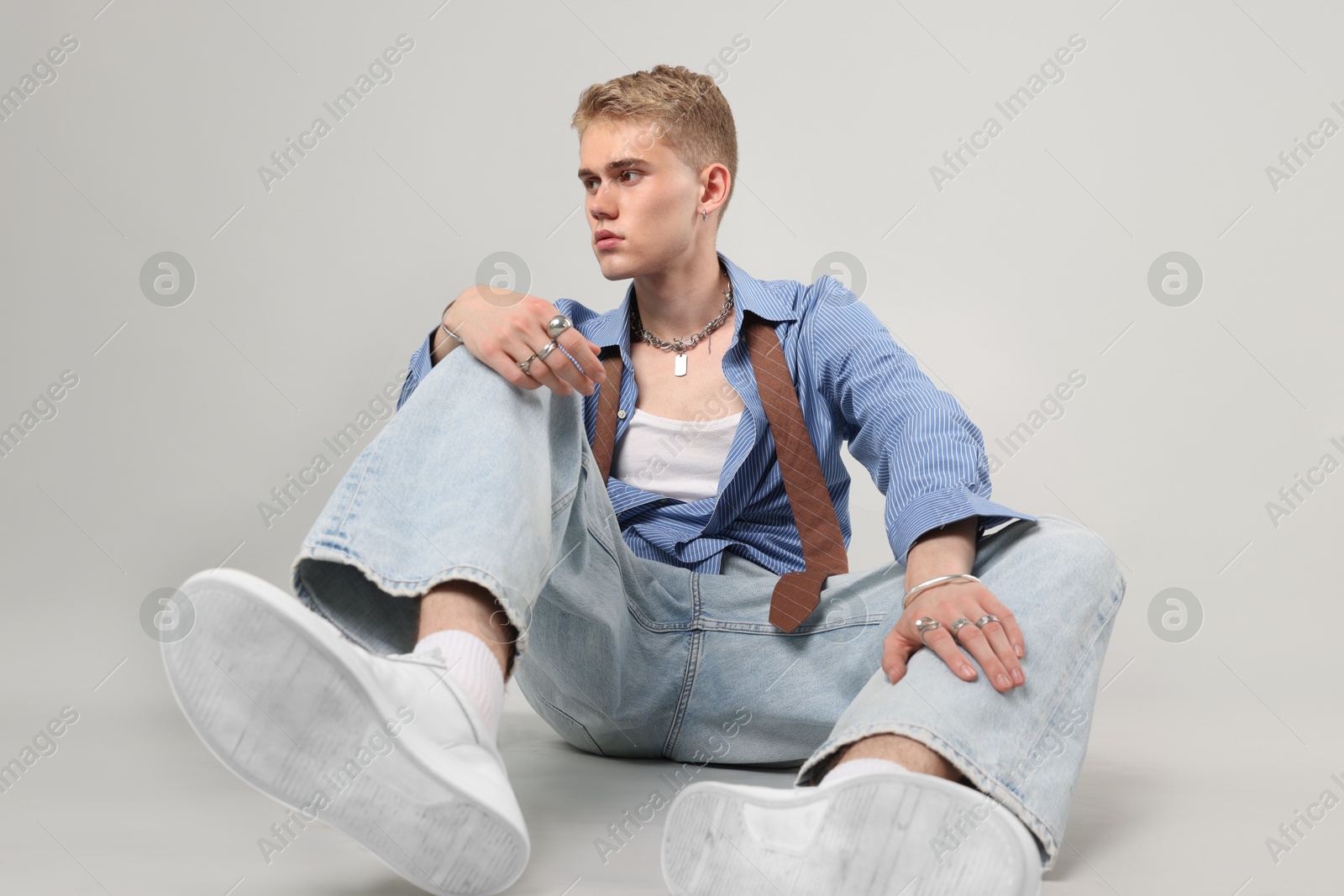 Photo of Handsome young man wearing stylish clothes on light grey background