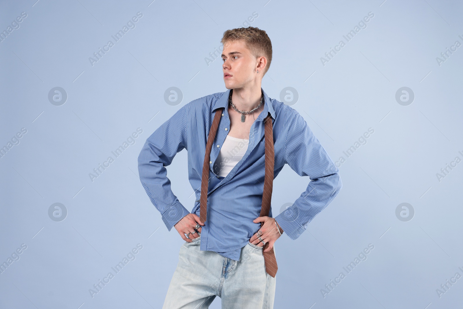 Photo of Handsome young man wearing stylish clothes on light grey background