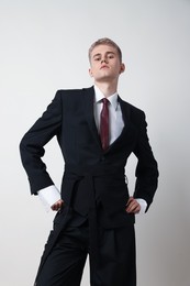 Photo of Handsome young man wearing stylish suit on white background