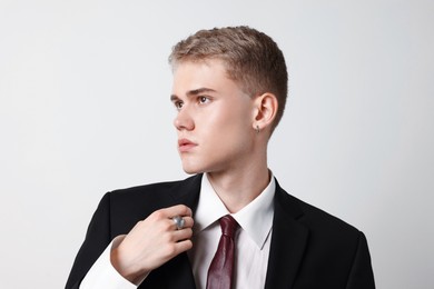 Photo of Handsome young man wearing stylish suit on white background