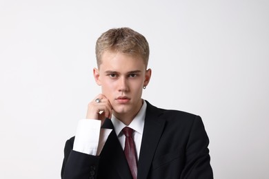 Photo of Handsome young man wearing stylish suit on white background