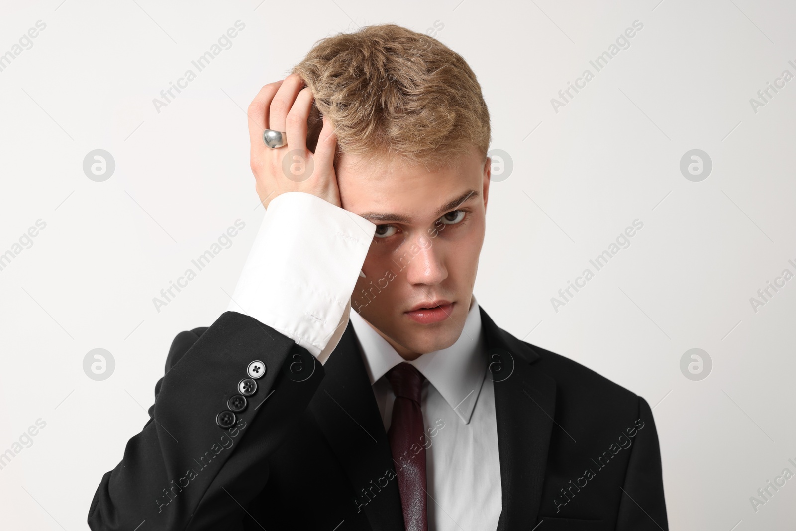 Photo of Handsome young man wearing stylish suit on white background